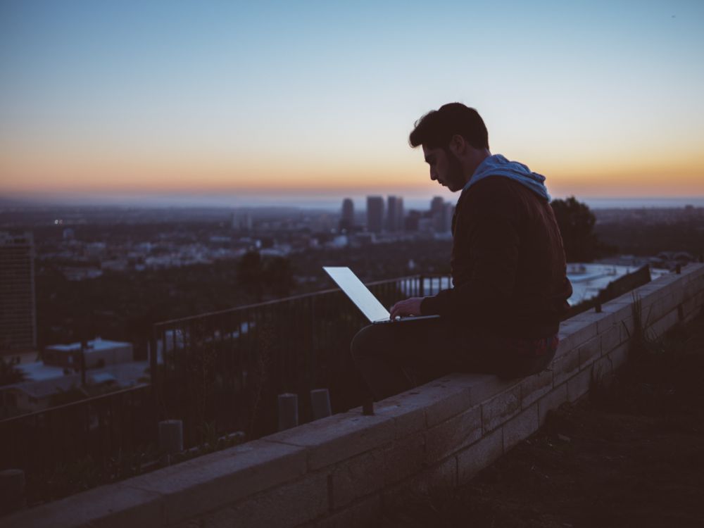 man-outside-on-laptop